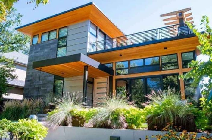 A modern home with premium thermally modified wood siding material from Mataverde Decking and Siding.