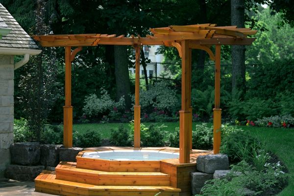 Wood deck with hot tub under a small pergola