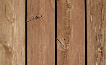 partially weathered redwood deck planks